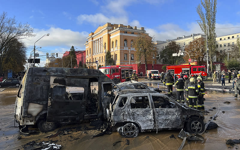 Rescue workers survey the scene of a Russian attack on Kyiv