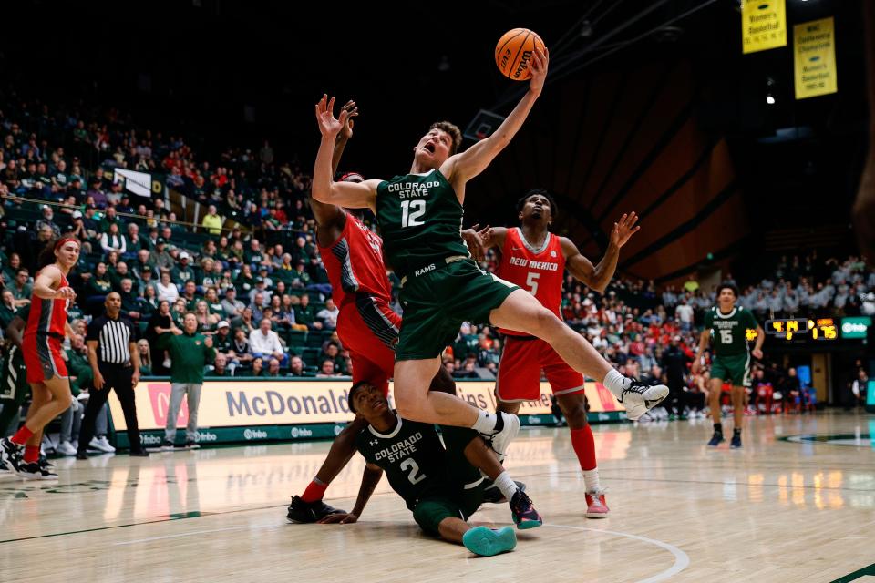 Mar 3, 2023; Fort Collins, Colorado, USA; Colorado State Rams forward Patrick Cartier (12) grabs a rebound against New Mexico Lobos forward Morris Udeze (24) as guard Tavi Jackson (2) looks on from the floor and guard Jamal Mashburn Jr. (5) defends in the second half at Moby Arena. Mandatory Credit: Isaiah J. Downing-USA TODAY Sports