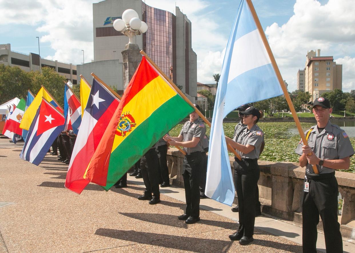 Brandon Rusch, of Lakeland, and fellow members of the Polk State College multi agency Police Academy present the parade of flags representing 26 nations.