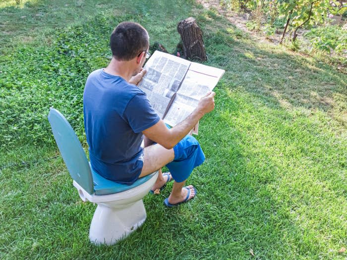 a man sitting on a toilet