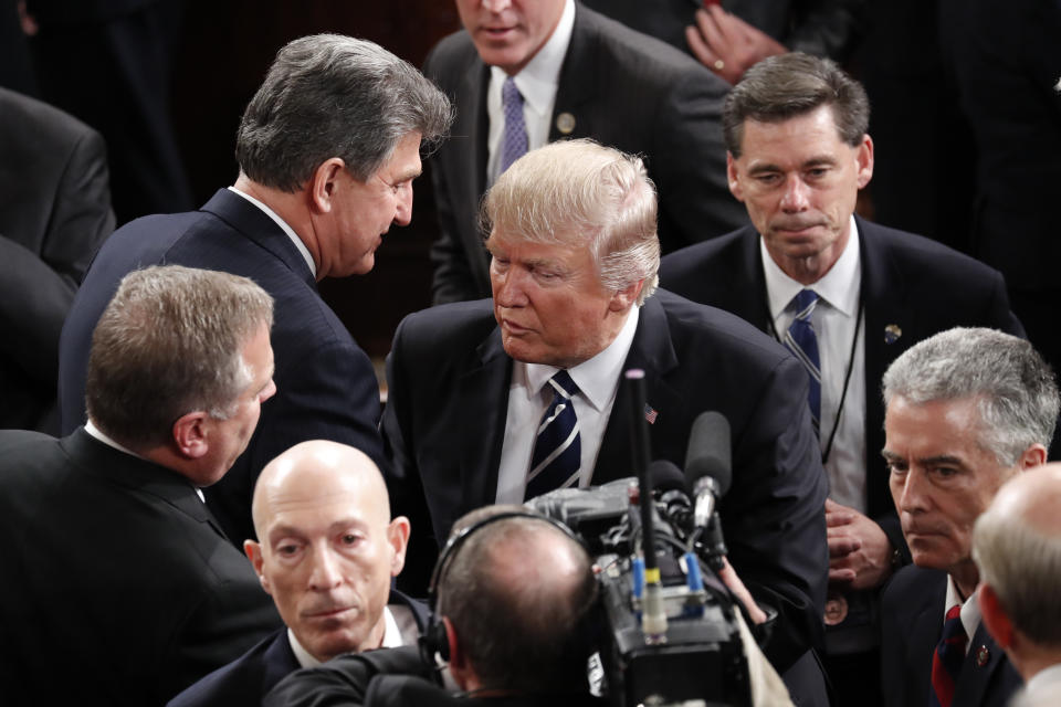 FILE - In this Feb. 28, 2017 file photo, President Donald Trump walks past Sen. Joe Manchin, D-W.Va. on Capitol Hill in Washington following the president's address to a joint session of Congress. Manchin said Wednesday, Nov. 15, 2023, that if voters give Trump another term in Washington, “he will destroy Democracy in America.” (AP Photo/Pablo Martinez Monsivais, file)