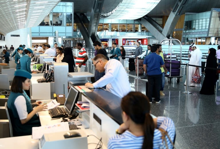 Passengers check-in at Hamad International Airport in Doha. Qatar Airways has made Doha a global hub in just a few years, but barring it from Gulf states' airspace could threaten its position as a major transcontinental carrier