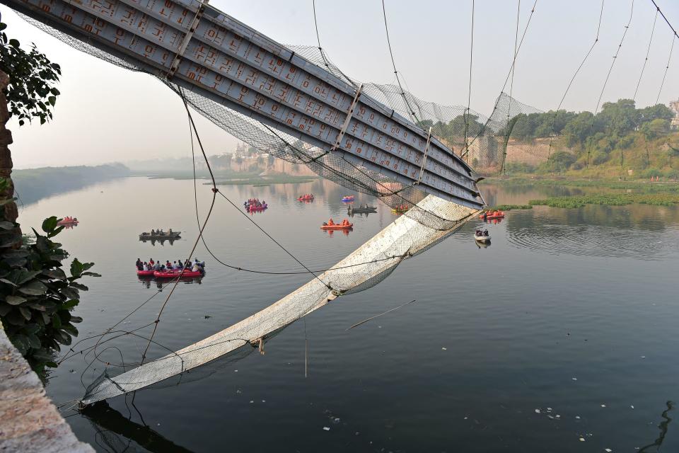 Rescue personnel conduct search operations after a bridge across the river Machchhu collapsed at Morbi in India's Gujarat state on October 31, 2022. / Credit: SAM PANTHAKY/AFP/Getty