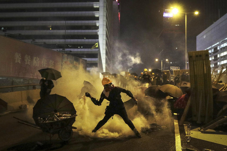 A protester throws a tear gas canister which was fired by riot police during a protest in Hong Kong, Sunday, July 28, 2019. Police fired tear gas at protesters in Hong Kong on Sunday for the second night in a row in another escalation of weeks-long pro-democracy protests in the semi-autonomous Chinese territory. (Ring Yu/HK01 via AP)