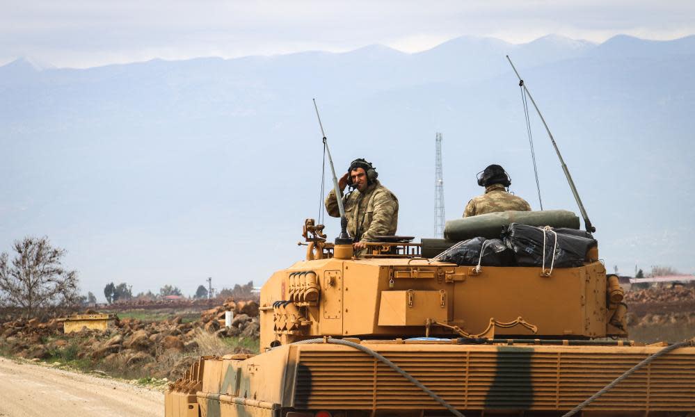 Turkish soldiers in a tank are transported as part of Operation Olive Branch, after dozens of airstrikes hit more than 150 targets in Afrin, Syria. 