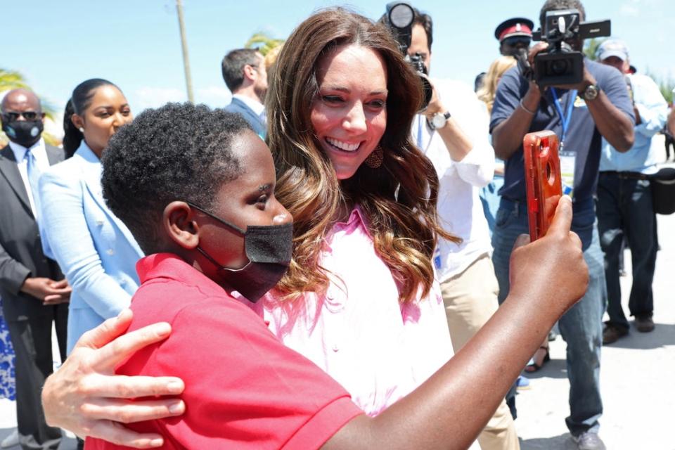 Duchess of Cambridge takes a selfie with a child during a visit to a Fish Fry (REUTERS)