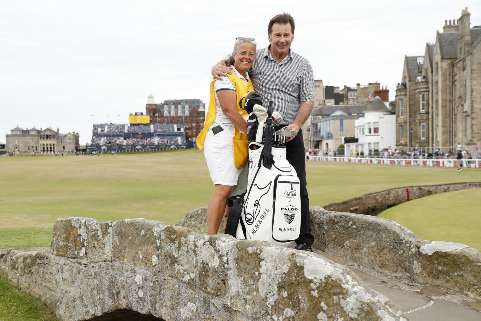 England's Nick Faldo and his former caddie Fanny Sunneson poses for a photo on the Swilken Bridge during a 'Champions round' as preparations continue for the British Open golf championship on the Old Course at St. Andrews, Scotland, Monday July 11, 2022. The Open Championship returns to the home of golf on July 14-17, 2022, to celebrate the 150th edition of the sport's oldest championship, which dates to 1860 and was first played at St. Andrews in 1873. (AP Photo/Peter Morrison)