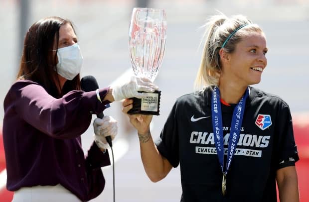 NWSL commissioner Lisa Baird, left, presents the Challenge Cup to Rachel Daly of the Houston Dash after the championships game in July.