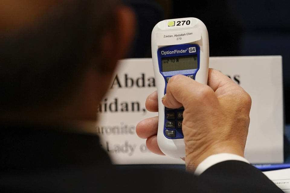 Bishop Abdallah Elias Zaidan, of Our Lady of Lebanon Maronite Catholic Church in Lewisville, Texas, holds his voting device during the Fall General Assembly meeting of the United States Conference of Catholic Bishops, Wednesday, Nov. 17, 2021, in Baltimore.(AP Photo/Julio Cortez)