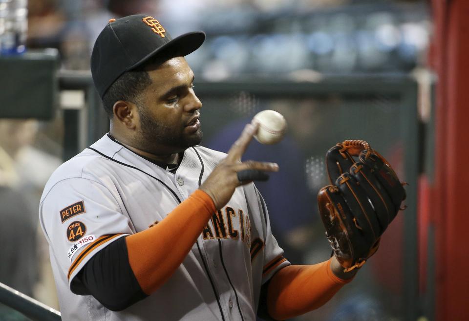 San Francisco Giants third baseman Pablo Sandoval warms up in the dugout prior to a baseball game against the Arizona Diamondbacks Friday, June 21, 2019, in Phoenix. (AP Photo/Ross D. Franklin)