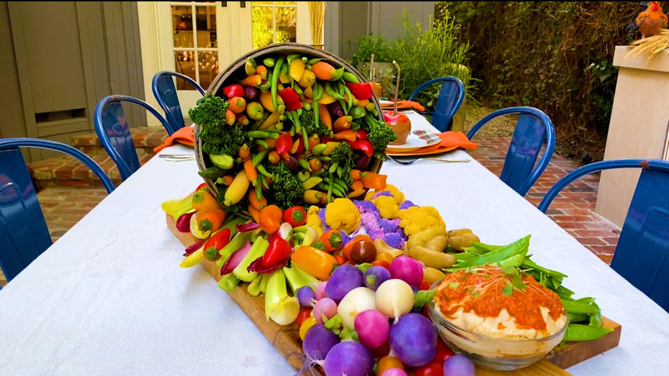 This bountiful Thanksgiving dinner table centerpiece overflowing with yummy veggies will definitely turn heads. (Photo: Yahoo Life)