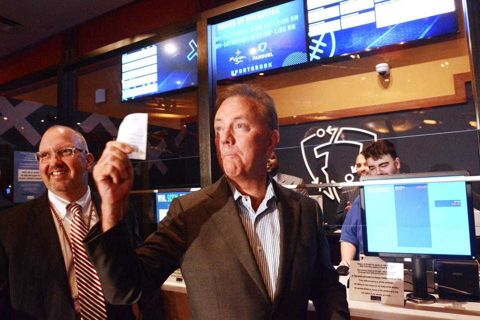 Gov. Ned Lamont holds the first sports betting slip next to James Gessner, Mohegan Sun tribal chairman, on Sept. 30, during the first day of sports betting at  the Mohegan Sun Casino. Foxwoods Resort Casino also started sports betting that day.