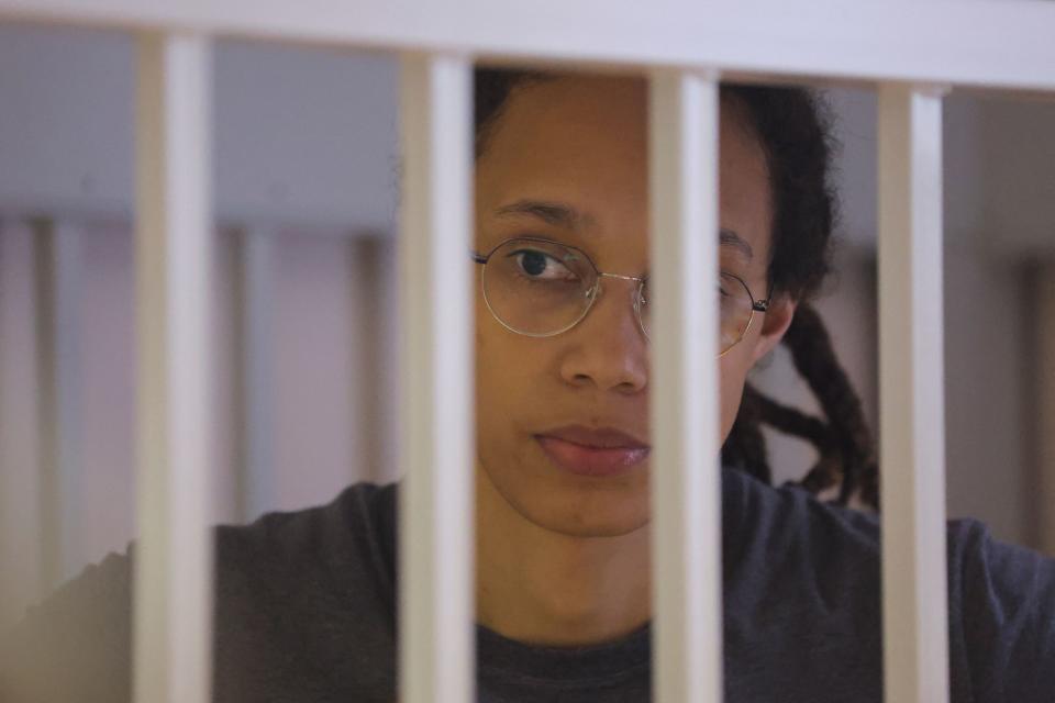 US' Women's National Basketball Association (NBA) basketball player Brittney Griner, who was detained at Moscow's Sheremetyevo airport and later charged with illegal possession of cannabis, waits for the verdict inside a defendants' cage during a hearing in Khimki outside Moscow, on August 4, 2022. - A Russian court found Griner guilty of smuggling and storing narcotics after prosecutors requested a sentence of nine and a half years in jail for the athlete. (Photo by EVGENIA NOVOZHENINA / POOL / AFP) (Photo by EVGENIA NOVOZHENINA/POOL/AFP via Getty Images)