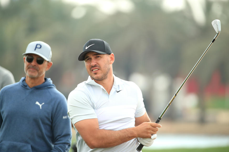 Brooks Koepka of The United States in action as his swing coach Claude Harmon III looks on during the Pro-Am ahead of the Abu Dhabi HSBC Championship at Abu Dhabi Golf Club on January 15, 2020, in Abu Dhabi, United Arab Emirates. (Photo by Andrew Redington/Getty Images)