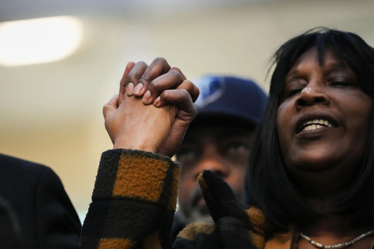 RowVaughn Wells, mother of Tyre Nichols, who died after being beaten by Memphis police officers, holds hands with civil rights Attorney Ben Crump at a news conference in Memphis, Tenn., Friday, Jan. 27, 2023. (AP Photo/Gerald Herbert)