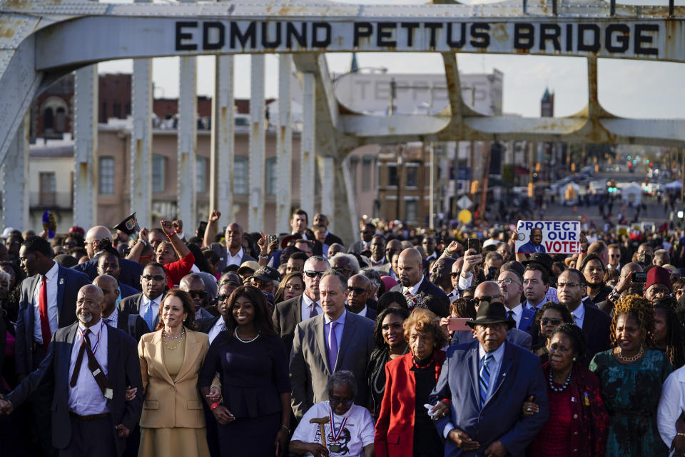 Vice President Kamala Harris marches on the Edmund Pettus Bridge after speaking in Selma, Ala., on the anniversary of "Bloody Sunday," a landmark event of the civil rights movement, Sunday, March 6, 2022. (AP Photo/Brynn Anderson)