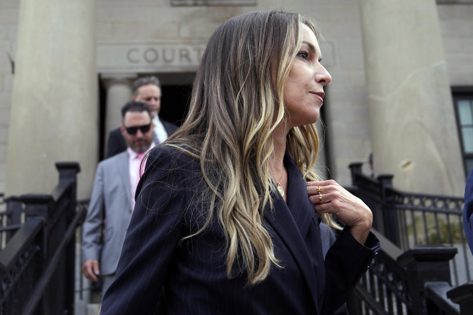Karen Read leaves Norfolk Superior Court after the opening day of her trial, Monday, April 29, 2024, in Dedham, Mass. Read is charged with killing her Boston police officer boyfriend by intentionally driving her SUV into him. (AP Photo/Charles Krupa)