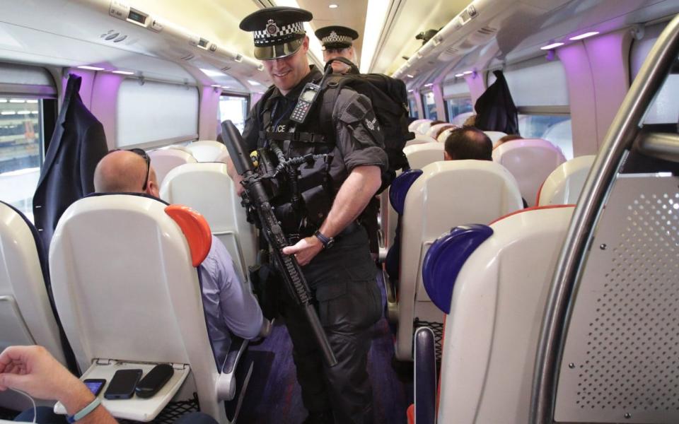 Armed British Transport Police Specialist Operations officers on board a Virgin train to Birmingham New Street at Euston  - Credit:  Yui Mok/PA