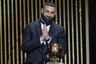 FILE - Real Madrid's Karim Benzema acknowledges the audience after winning the 2022 Ballon d'Or trophy during the 66th Ballon d'Or ceremony at Theatre du Chatelet in Paris, France, Monday, Oct. 17, 2022. (AP Photo/Francois Mori, File)