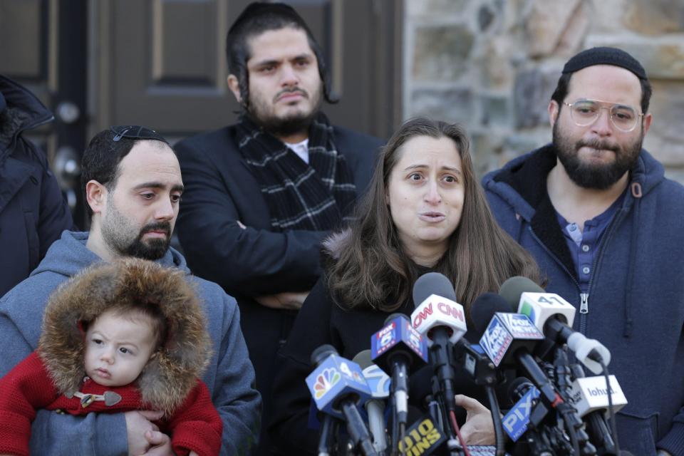 Surrounded primarily by family, Nicky Kohen, the daughter of Josef Neumann who died following an attack on a Hanukkah celebration, speaks to reporters in front of her home in New City, N.Y. A New York Domestic Hate Crimes Bill now carries his name.