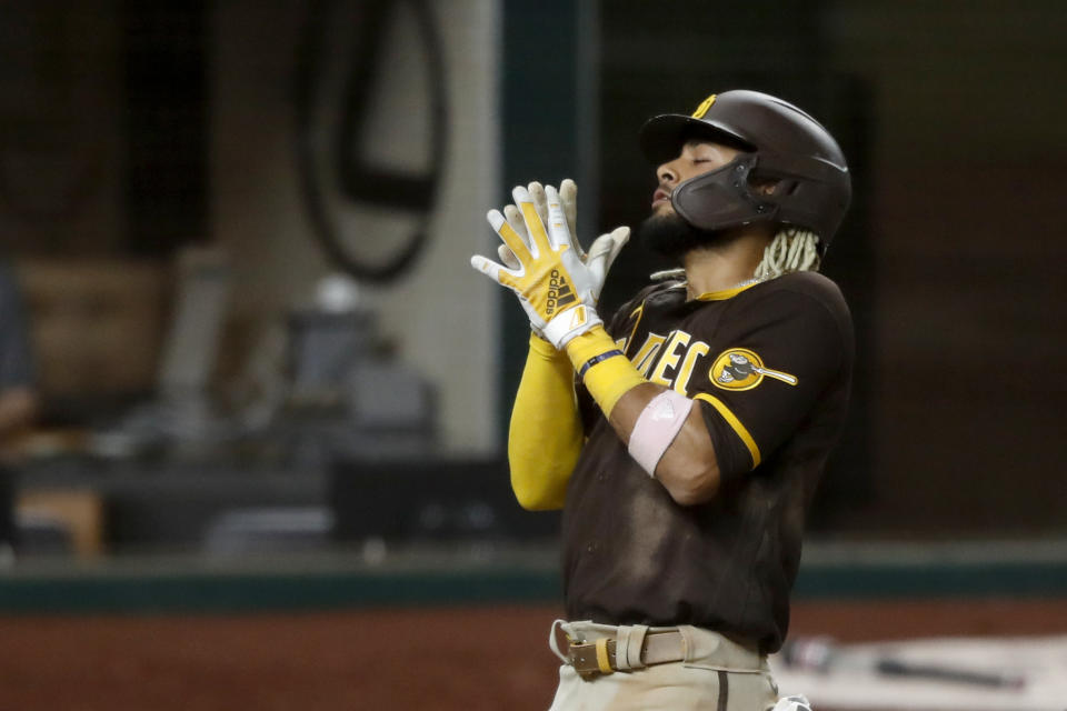 San Diego Padres' Fernando Tatis Jr., celebrates his three-run home run as he crosses the plate in the seventh inning of a baseball game against the Texas Rangers in Arlington, Texas, Monday Aug. 17, 2020. The shot scored Austin Hedges and Trent Grisham (AP Photo/Tony Gutierrez)
