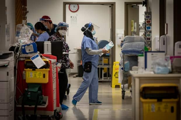 Nurses wearing personal protective equipment walk through the emergency department at Scarborough General Hospital in Toronto on Apr. 8, 2021. (Evan Mitsui/CBC - image credit)