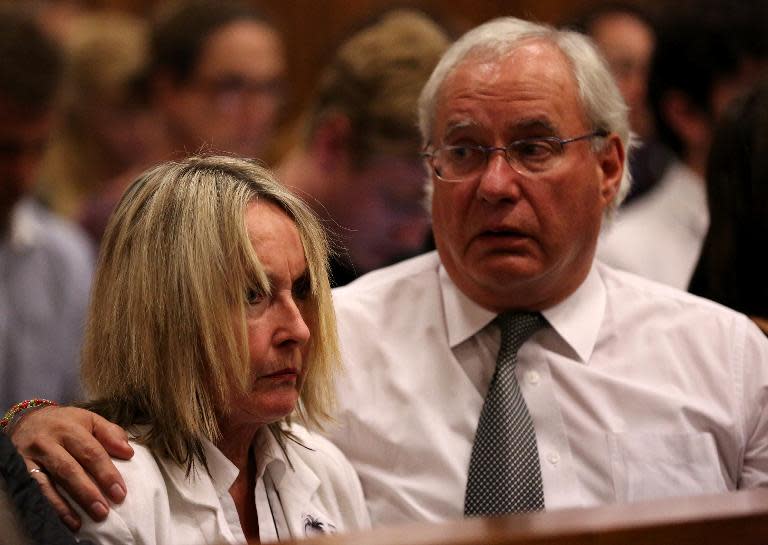 Jane Steenkamp (L), Reeva Steenkamp's mother is comforted by a relative after her dead daughter's picture was shown on screen during the trial of Oscar Pistorius at North Gauteng High Court in Pretoria on April 9, 2014