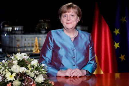 German Chancellor Angela Merkel poses for photographs after the television recording of her annual New Year's speech at the Chancellery in Berlin, Germany, December 30, 2016. REUTERS/Markus Schreiber/Pool