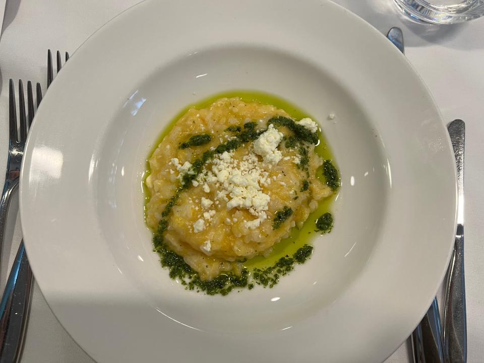 Squash risotto with green sauce on a plate