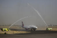 A Yemen Airways plane is greeted with a water spray salute at the Sanaa international airport in Sanaa, Yemen, Monday, May, 16, 2022. The first commercial flight in six years took off from Yemen’s rebel-held capital on Monday, officials said, part of a fragile truce in the county’s grinding civil war. (AP Photo/Hani Mohammed)