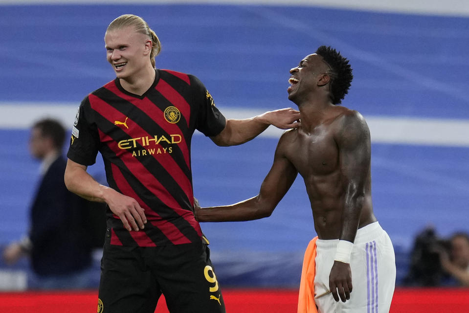 Manchester City's Erling Haaland, left, greets Real Madrid's Vinicius Junior at the end of the Champions League semifinal first leg soccer match between Real Madrid and Manchester City at the Santiago Bernabeu stadium in Madrid, Spain, Tuesday, May 9, 2023. (AP Photo/Manu Fernandez)