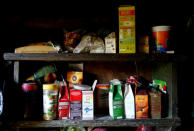 Food boxes lie on shelves inside the hut of Tamara and Yuri Baikov situated in a forest near the village of Yukhovichi, Belarus, May 24, 2018. REUTERS/Vasily Fedosenko