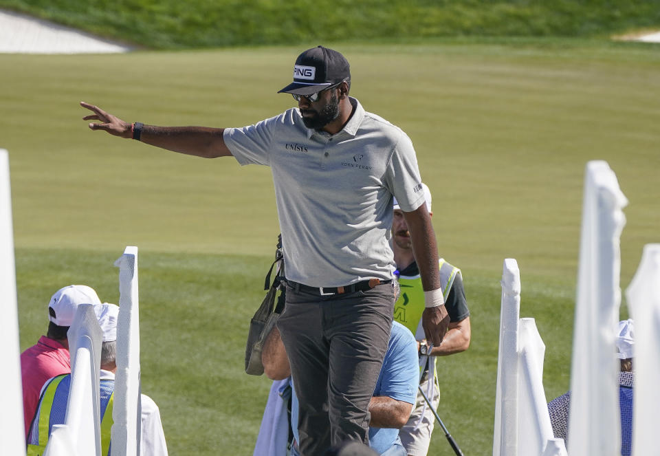 Sahith Theegala waves to fans after finishing up his round during the second round of the Phoenix Open golf tournament Friday, Feb. 11, 2022, in Scottsdale, Ariz. (AP Photo/Darryl Webb)