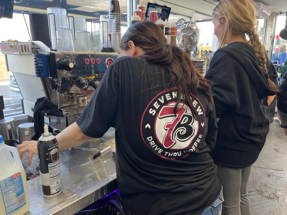 Employees make coffee for customers inside the 7 Brew location in Flowood.