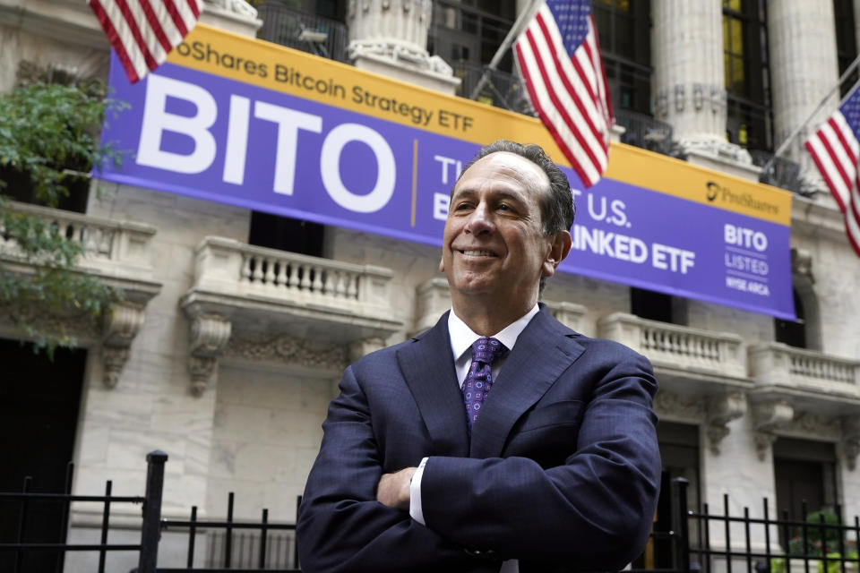 ProShares CEO Michael Sapir poses for photos outside the New York Stock Exchange before his company is listed, Tuesday, Oct. 19, 2021. ProShares will launch the country's first exchange-traded fund linked to Bitcoin. (AP Photo/Richard Drew)