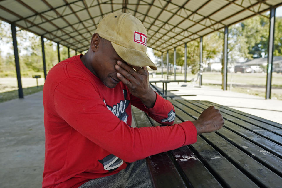 Darius Harris, 45, a construction worker, wipes his face as he speaks about being targeted by police in Lexington, Miss., during an interview in Tchula, Miss., on Oct. 21, 2022. He recalled being repeatedly harassed, threatened, and arrested by police and as a result, he avoids shopping or visiting his brother who lives in that small city. Harris is one of five plaintiffs in a federal lawsuit that accuses the Lexington Police Department of subjecting Black residents to intimidation, excessive force and false arrests. (AP Photo/Rogelio V. Solis)