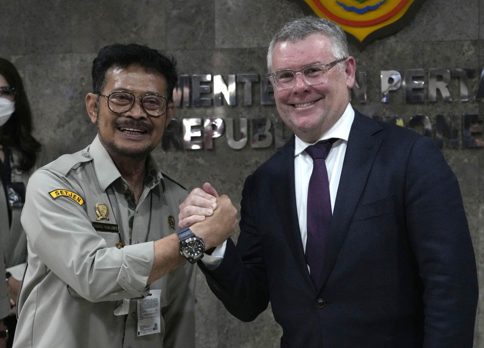 Australian Agriculture Minister Murray Watt, right, is greeted by his Indonesian counterpart Syahrul Yasin Limpo after their meeting in Jakarta, Indonesia, Thursday, July 14, 2022, (AP Photo/Tatan Syuflana)