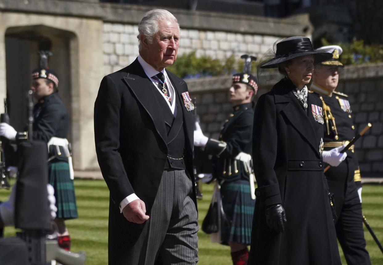 Prince Charles, the Prince of Wales and Princess Anne, the Princess Royal walk in the procession, ahead of Britain Prince Philip's funeral at Windsor Castle, Windsor, England, Saturday April 17, 2021.