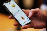 <p>An Apple employee demonstrates the Animoji feature on the new iPhone X at the Apple Store Union Square on November 3, 2017, in San Francisco, California.<br> Apple’s flagship iPhone X hits stores around the world as the company predicts bumper sales despite the handset’s eye-watering price tag, and celebrates a surge in profits. </p>