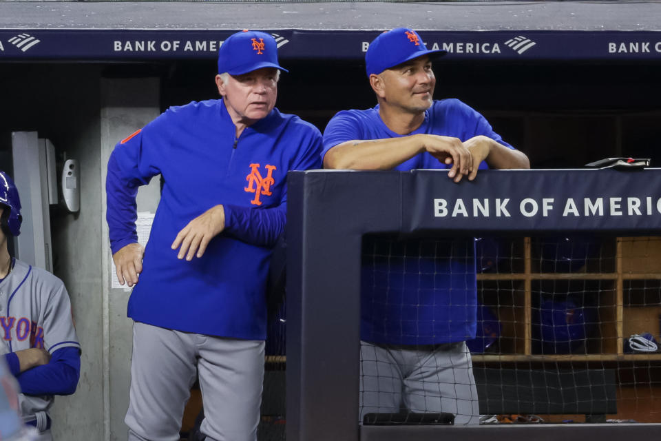 New York Mets manager Buck Showalter looks on with hitting coach Eric Chavez in the fourth inning of a baseball game against the New York Yankees, Monday, Aug. 22, 2022, in New York. (AP Photo/Corey Sipkin)