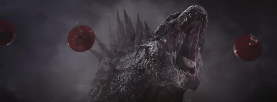 Godzilla roars fiercely with red lanterns dangling in the background.