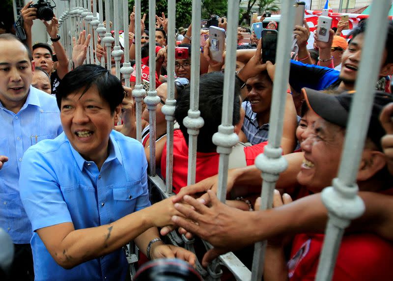 FILE PHOTO: Former senator Ferdinand "Bongbong" Marcos Jr and son of late former dictator Ferdinand Marcos is greeted by his supporters upon his arrival at the Supreme Court in metro Manila