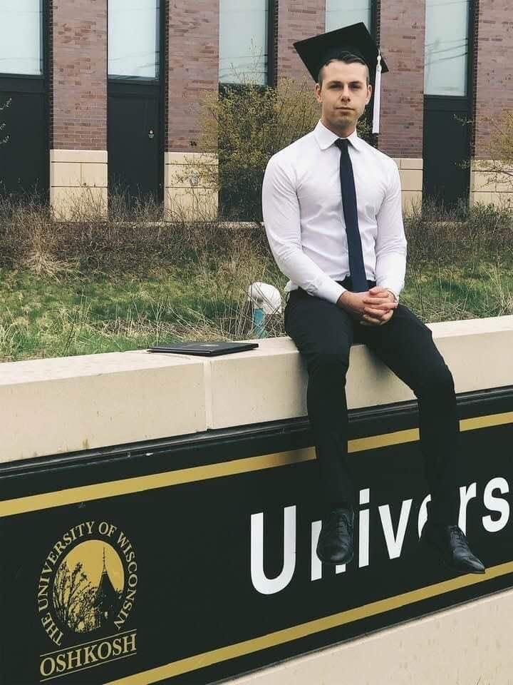 Brandon Colligan, 26, who died by suicide June 17, 2022, poses on the day of his graduation from the University of Wisconsin-Oshkosh.