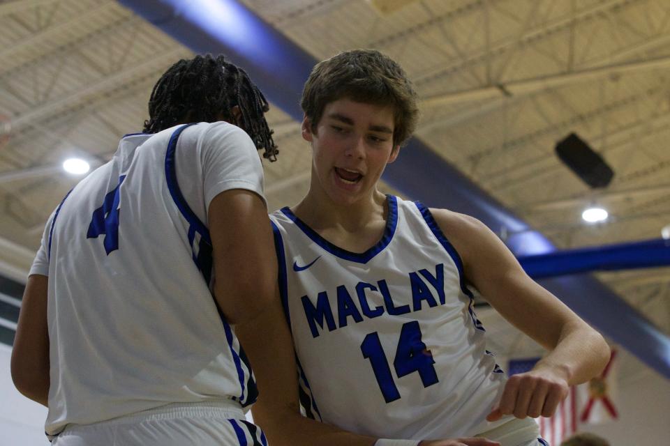 Maclay junior forward Caleb Heeuchan (14) celebrates with senior forward Jaquay Randolph (4) in a game against Crossroad Academy on Jan. 14, 2022, at Maclay School. The Marauders won 65-51.