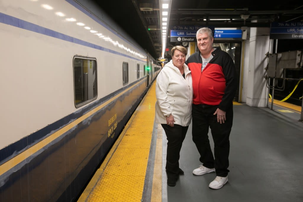 Lisa and Don Combs pose beside the Berlin sleeping car at Moynihan Train Hall at Penn Station, where the vintage train will depart just after 10 a.m. Sunday on the rear of an Amtrak. Michael Nagle