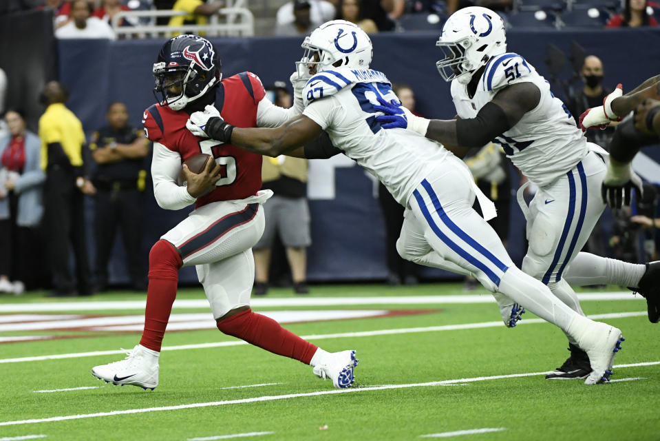 Houston Texans quarterback Tyrod Taylor (5) is sacked by Indianapolis Colts defensive end Al-Quadin Muhammad (97) during the first half of an NFL football game, Sunday, Dec. 5, 2021, in Houston. (AP Photo/Justin Rex )