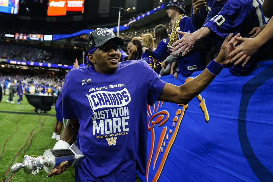 Washington quarterback Michael Penix Jr. grets fans after the Sugar Bowl CFP NCAA semifinal college football game between Washington and Texas, Tuesday, Jan. 2, 2024, in New Orleans. Washington won 37-31. (AP Photo/Jacob Kupferman)