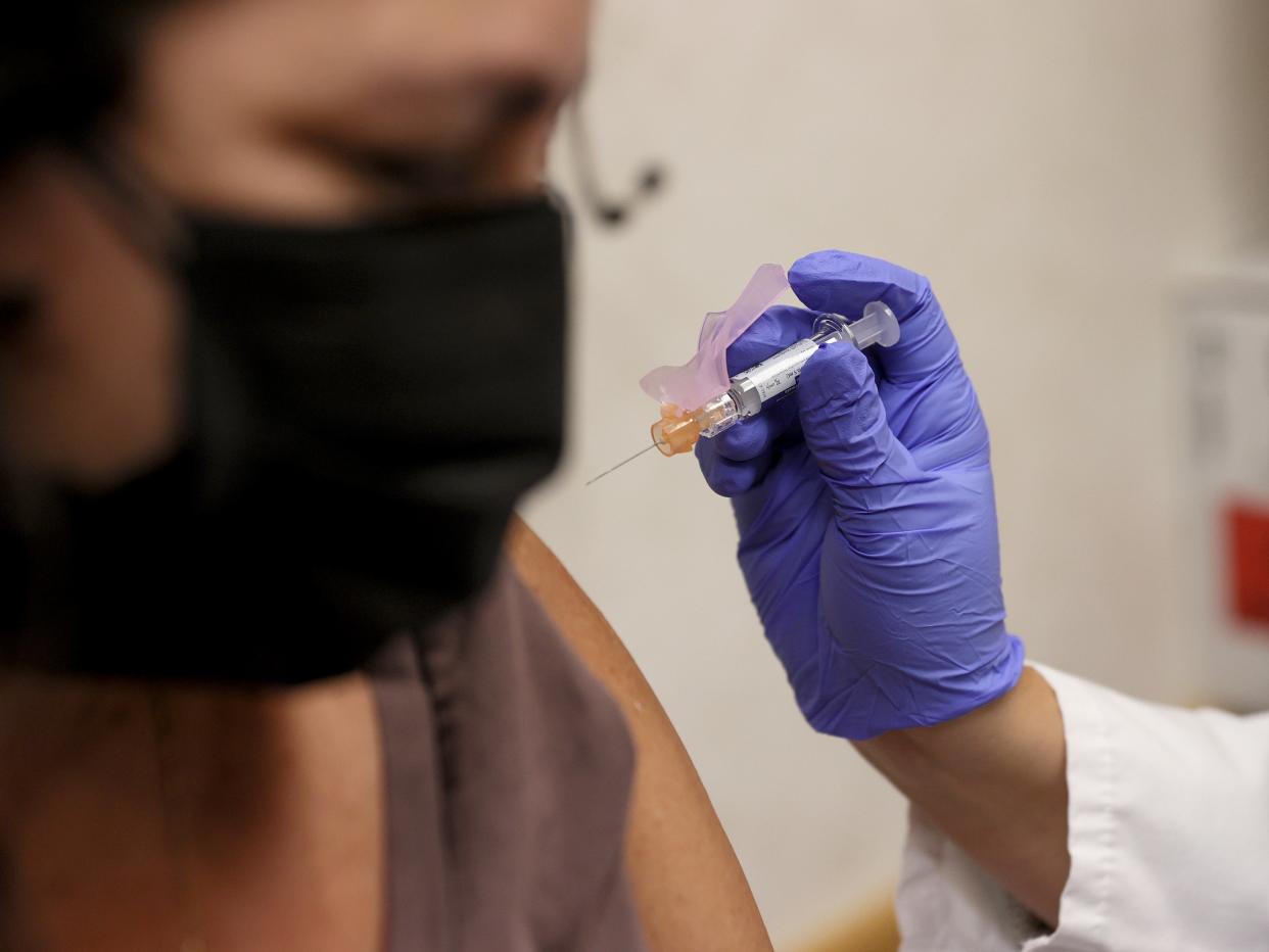 Susana Sanchez, a Nurse Practitioner, administers a flu vaccination to Ana Maria Flores at a CVS pharmacy and MinuteClinic on September 10, 2021 in Miami, Florida (Getty Images)