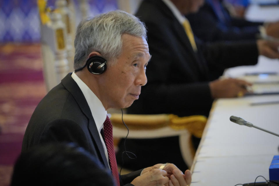 Singapore's Prime Minister Lee Hsien Loong listen's to South Korea's President Yoon Suk-yeol, speech during the ASEAN - South Korea Summits (Association of Southeast Asian Nations) in Phnom Penh, Cambodia, Friday, Nov. 11, 2022. The ASEAN summit kicks off a series of three top-level meetings in Asia, with the Group of 20 summit in Bali to follow and then the Asia Pacific Economic Cooperation forum in Bangkok. (AP Photo/Anupam Nath)