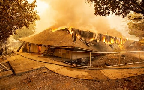 The Feather River Hospital burns down during the Camp fire in Paradise - Credit: AFP